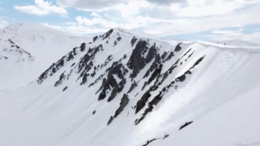 Huge rocks Mt Shpytsi covered with white snow, Carpathian Mountains. Alpine mountain landscape with snow and rocks.