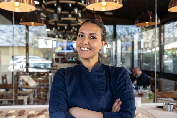 stock image Young north african chef woman smiling on camera at the restaurant - Focus on face