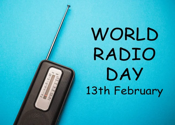 World Radio Day 13 February text with radio on blue background. Selective focus.