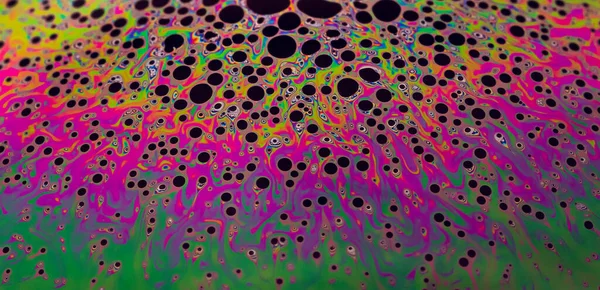 Multicolor psychedelic colors in a soap bubble Closeup Soap bubble