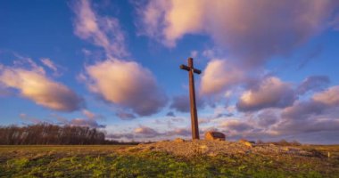 Cross in the evening landscape. Serene evening scene with a cross in the field. . High quality 4k footage