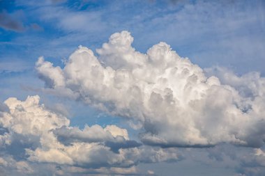 Cumulus clouds in the blue summer sky, storm season