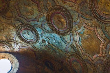 Güzel ve karmaşık renkli tavan sanat eserleri çarpıcı dokuları ve detaylarıyla benzersiz dairesel tasarımlar sergiliyor. Pompei şehrinin antik kalıntıları, Napoli, İtalya.