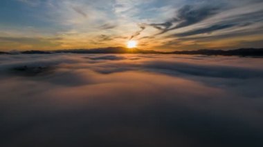 4K Hyperlapse aerial view drone flying over sea of fog at sunrise, Khoa Khai nui mountain, Phang Nga, Thailand