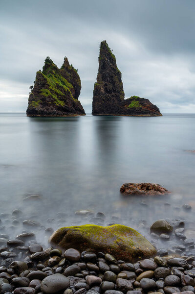 Alagoa Bay, amazing beach on Flores Island in Azores, Portugal. Seascape or costal landscape in a travel destination and tourist attraction, of rare natural beauty. Black sand beach and round stones.