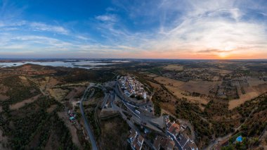 Amazing aerial view of the medieval village of Monsaraz, Alentejo, Portugal. Beautiful landscape at sunset. Historic castle, tourist attraction and holiday travel destination.  clipart