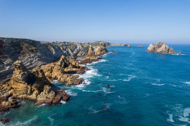 Playa de la Arnia 'nın dramatik manzarası, Cantabria, İspanya. Arnia Plajı, gün batımında Asturias. İnanılmaz manzara, çizgiler, soyut şekiller güzel renkler..
