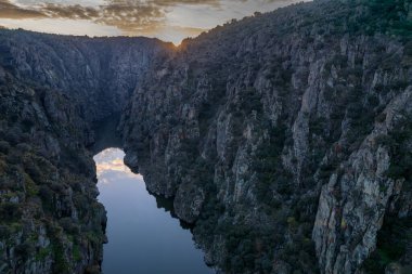 Amazing natural landscape with a panoramic view of the Douro River at sunset. From the Fraga do Puio viewpoint in the north of Portugal we can see the water running between the cliffs with a beautiful sunlight. clipart