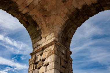 Partial view of ancient Roman triumphal arch, located in the Roman ruins of Caparra. Spain. clipart