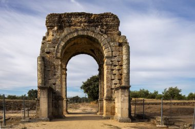 İspanya 'nın Caparra harabelerinde tarihi bir manzarayla çevrili antik Roma kemeri..