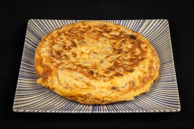 Süslü bir tabakta İspanyol omleti, geleneksel mutfak ve lezzetli lezzetler sergileniyor..