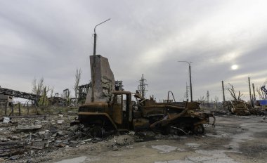 burnt cars and destroyed buildings of the workshop of the Azovstal plant in Mariupol war in Ukraine with Russia