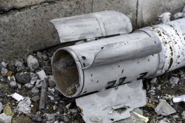 weapons rocket lying on the ground near the wall war in Ukraine with Russia