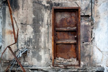 door and wall of destroyed and burnt house war in ukraine