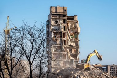 construction equipment destroys affected houses war in Ukraine with Russia