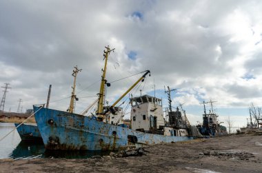 abandoned old damaged ships in the port without people during the war between Ukraine and Russia