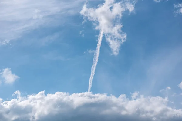 stock image contrail of a rocket launch in the blue sky war in Ukraine