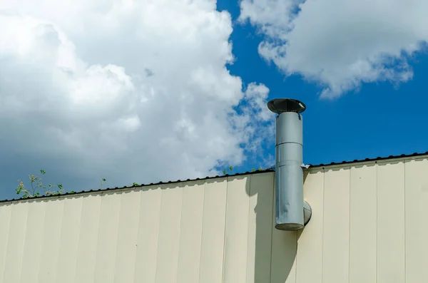 stock image heating metal chimney pipe on a blue sky background