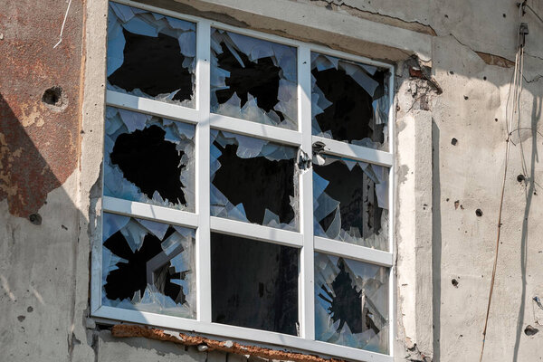 пустые окна поврежденного дома войны на Украине