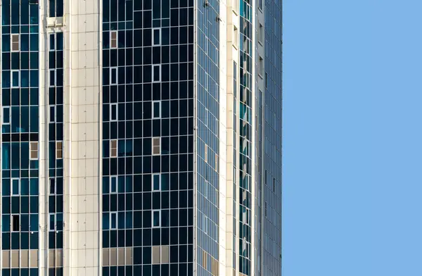 many windows and walls facade of a modern skyscraper without people architectural abstract pattern