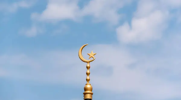 golden symbol of Islam against blue sky close up