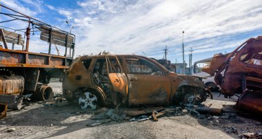 burnt military armored car on the street of the ruined city war Ukraine Russia