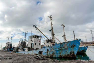 abandoned old damaged ships in the port without people during the war between Ukraine and Russia