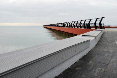modern pier without people and calm sea in autumn