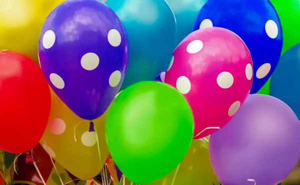 many bright colorful balloons with helium