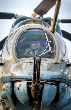 cockpit of a russian army military helicopter with a machine gun closeup