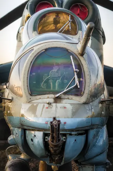 cockpit of a russian army military helicopter with a machine gun closeup