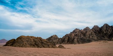 rocky mountains in the desert without people and blue sky with clouds in sharm el sheikh egypt landscape