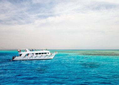 white cruise tourist boat on the background of the coast in the Red Sea in Sharm El Sheikh Egypt