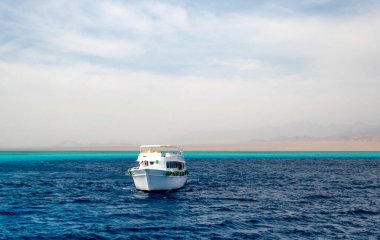 white cruise tourist boat on the background of the coast in the Red Sea in Sharm El Sheikh Egypt