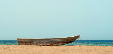 eski bir tekne içinde belgili tanımlık kum deniz ve ufuk arka planı