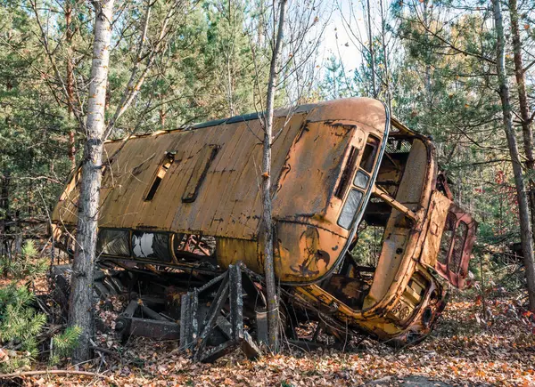 abandoned broken equipment car in the Chernobyl forest Ukraine in autumn