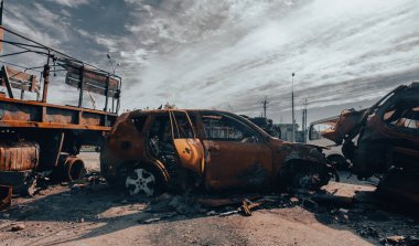 burnt military armored car on the street of the ruined city war Ukraine Russia