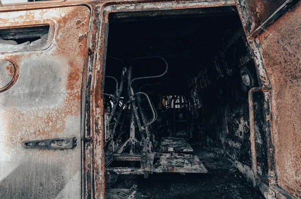 burnt military armored car on the street of the ruined city war Ukraine Russia