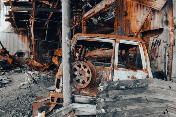 burnt military armored car on the street of the ruined city war Ukraine Russia