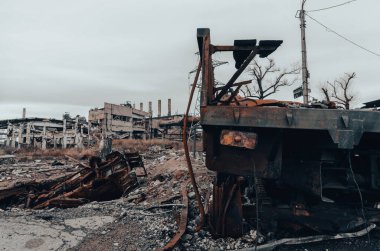 burnt cars and destroyed buildings of the workshop of the Azovstal plant in Mariupol war in Ukraine with Russia