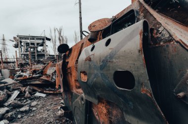 burnt tank and destroyed buildings of the Azovstal plant shop in Mariupol war in Ukraine with Russia