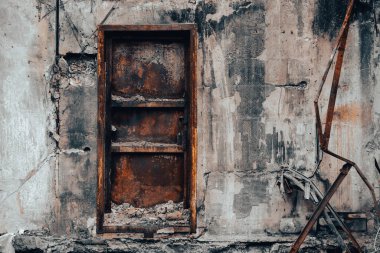 door and wall of destroyed and burnt house war in ukraine
