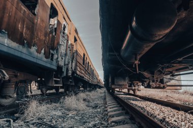 end of the road damaged and burnt trains war in Ukraine with Russia