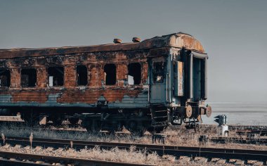 end of the road damaged and burnt trains war in Ukraine with Russia