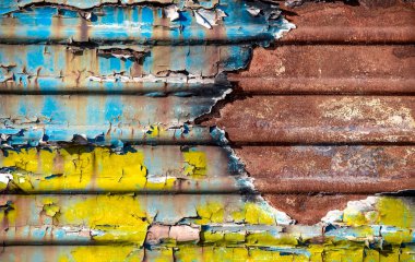 pattern rusty metal surface with remnants of blue and yellow paint paint national colors flag of ukraine
