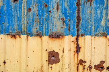 pattern explosion damaged blue yellow house wall war in Ukraine