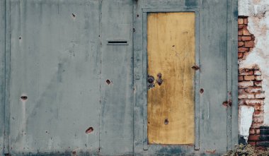 pattern explosion damaged blue yellow house wall war in Ukraine