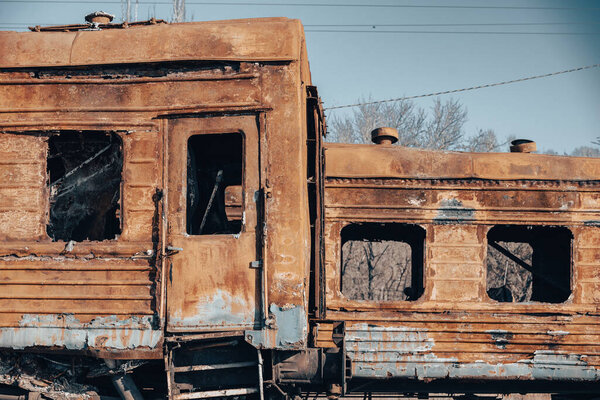 end of the road damaged and burnt trains war in Ukraine with Russia