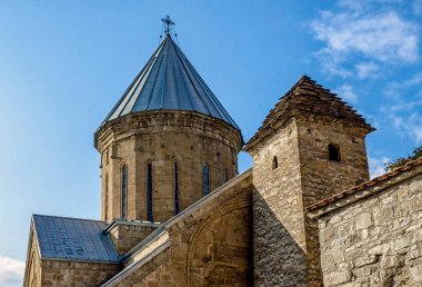 old antique christian church with dome and cross in Tbilisi Georgia on a background of blue sky and clouds