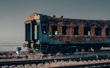 end of the road damaged and burnt trains war in Ukraine with Russia